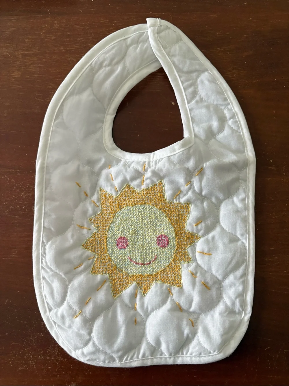 Hand embroidered sun quilted baby bib